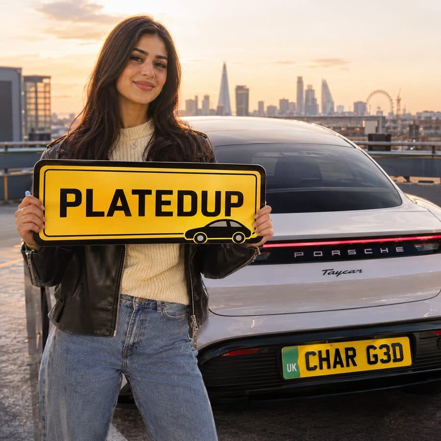 Woman holding a PlatedUp sign beside a silver Porsche Taycan with a Green Strip UK show plate on a London rooftop